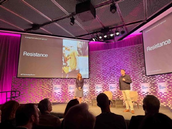 Amy Nordrum and Niall Firth stand on stage at EmTech AI with a slide behind them that reads 