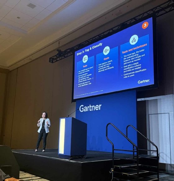 Melody Chien stands on stage at Gartner, presenting step 3 in governing unstructured data: tag and classify data.
