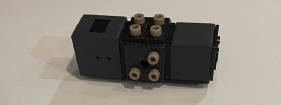 A 3-D model of a black-colored Q-CTRL quantum sensor sits on a white background.