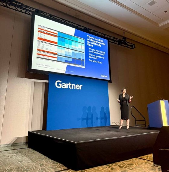 Roxane Edjlali stands on stage at Gartner, presenting a 26-point checklist for AI data readiness on a PowerPoint slide.