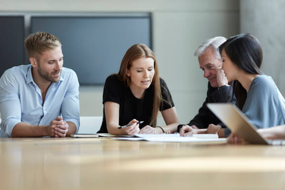 Business people reviewing paperwork in meeting