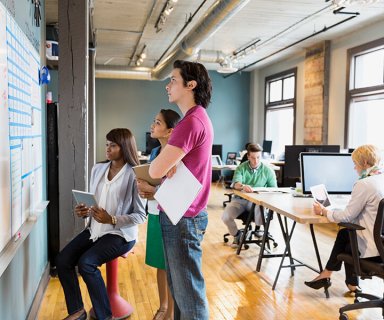 Group of entrepreneurs working in creative office space