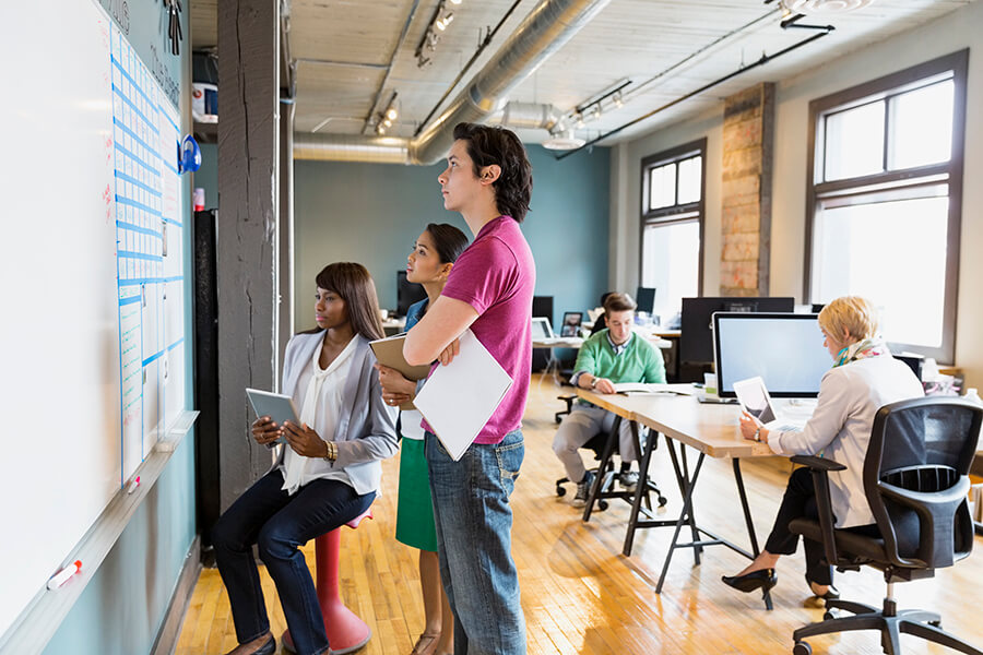 Group of entrepreneurs working in creative office space