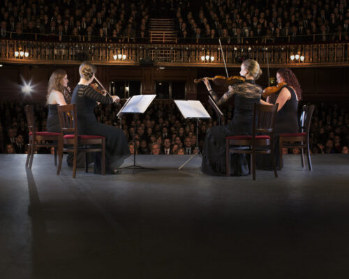 Quartet performing on stage in theater